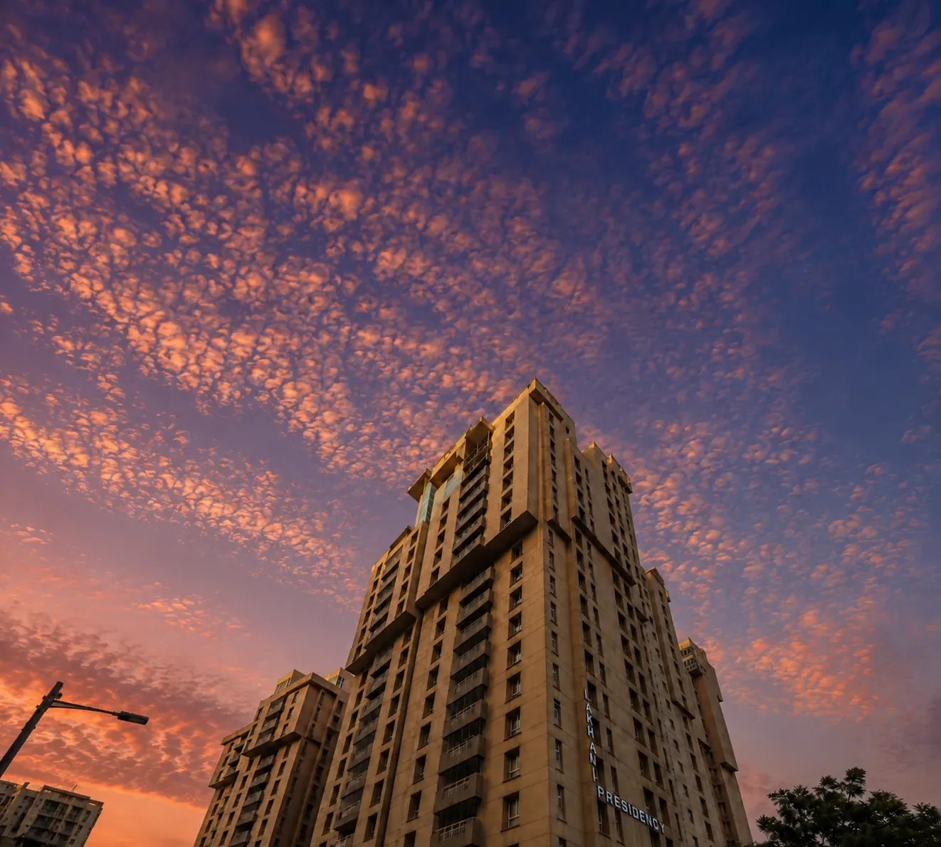 The tower against a sunset sky, seen from the foot of it.