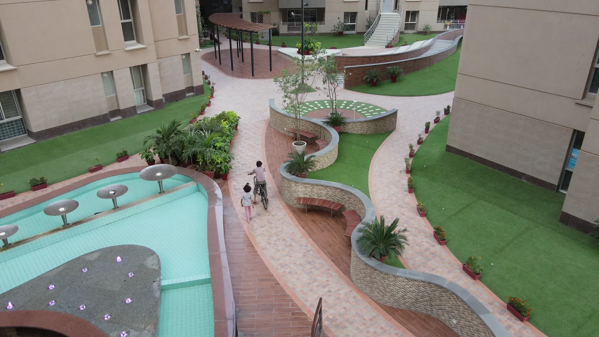 Residents cycling along the garden walkway in the afternoon.